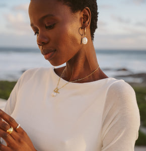 Woman wearing gold pearl jewelry 